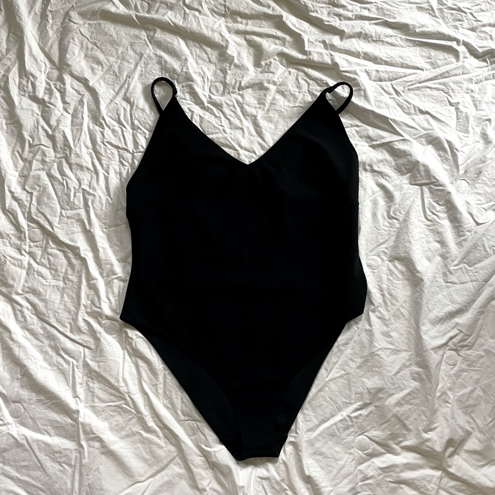 H&M loose fitting black body suit, size medium.